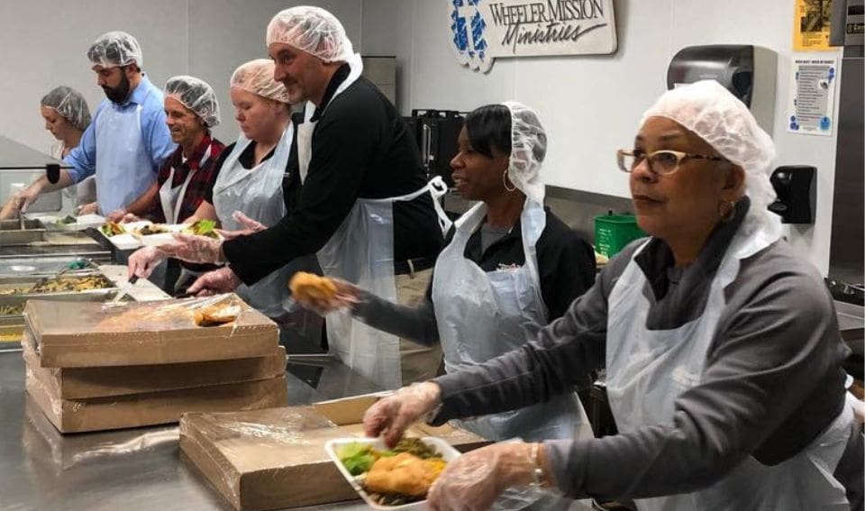 People serving food at Hearts 2 Soles Event presented by Forté Orthopedic Research Institute