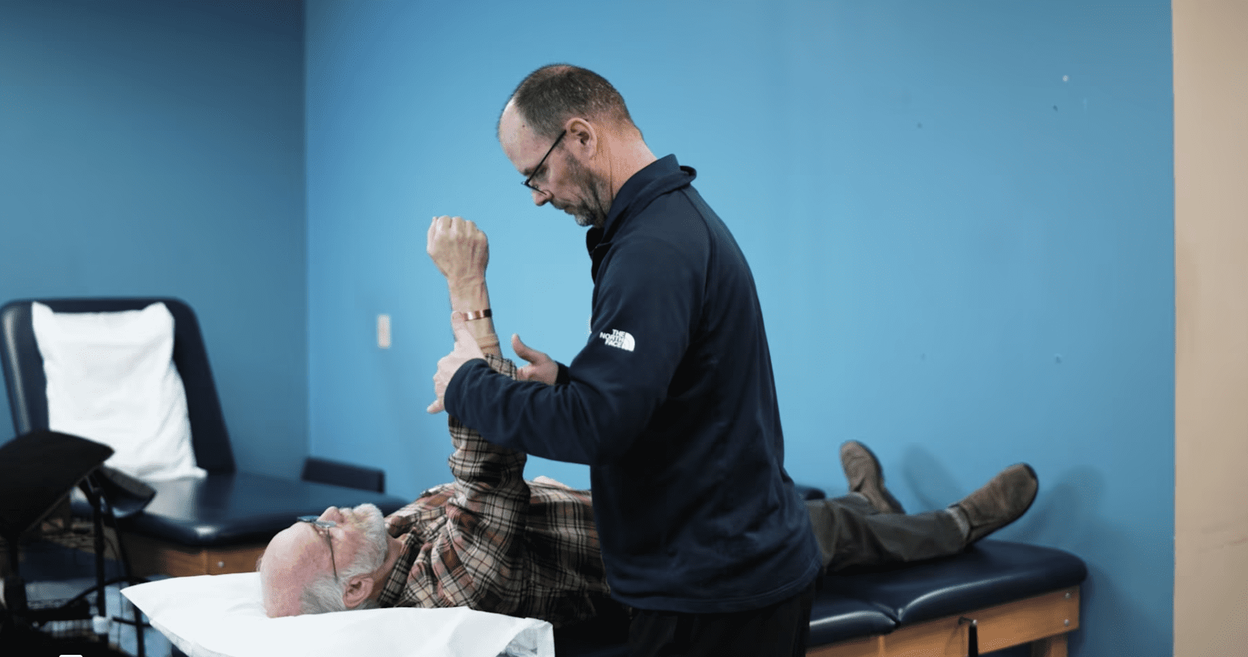 A physical therapist in Central Indiana treats a patient with shoulder pain