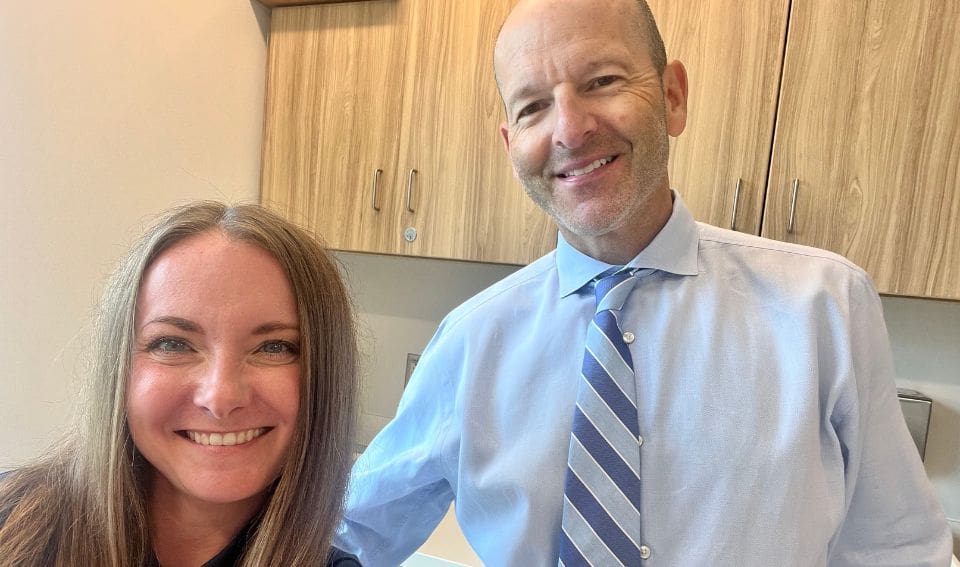 Dr. Lance Rettig pictured with female patient who received treatment for an elbow injury at Forté Sports Medicine