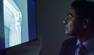 Dr. Joseph Maratt examining a patients x-ray image to determine plan for a computer-assisted knee replacement