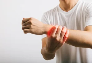 A person experiencing wrist pain in Central Indiana