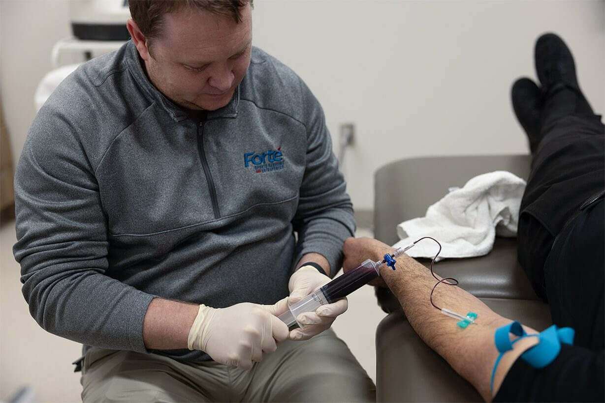 A Nurse is taking Blood from a Patient, Showcasing Orthobiologics Services in Greenwood, IN