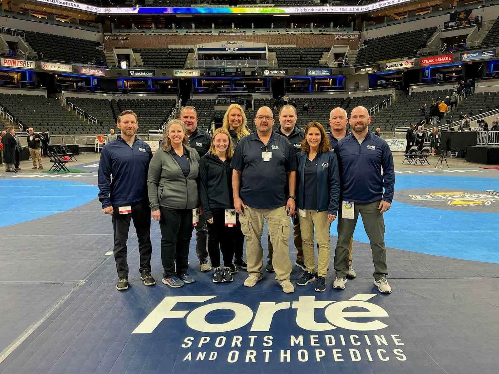 Athletic trainers strike a pose for a photo at Forte Sports Medicine event
