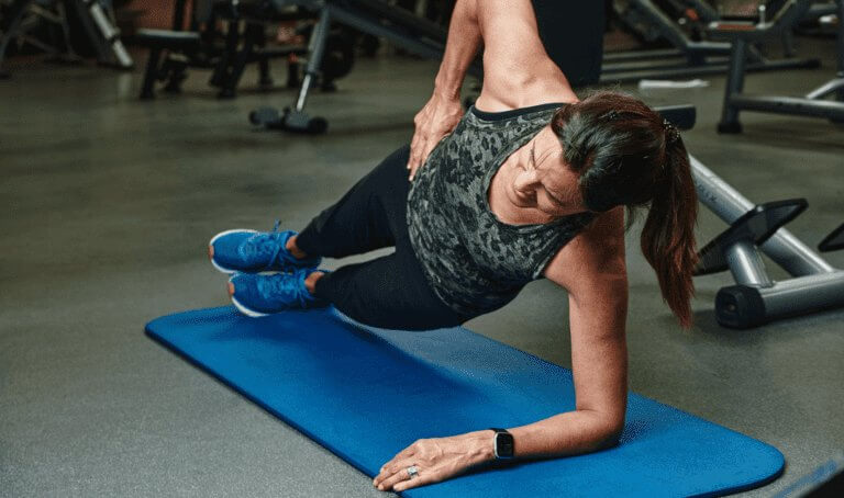Woman does push-ups to promote fitness for those seeking care at Forte Sports Medicine