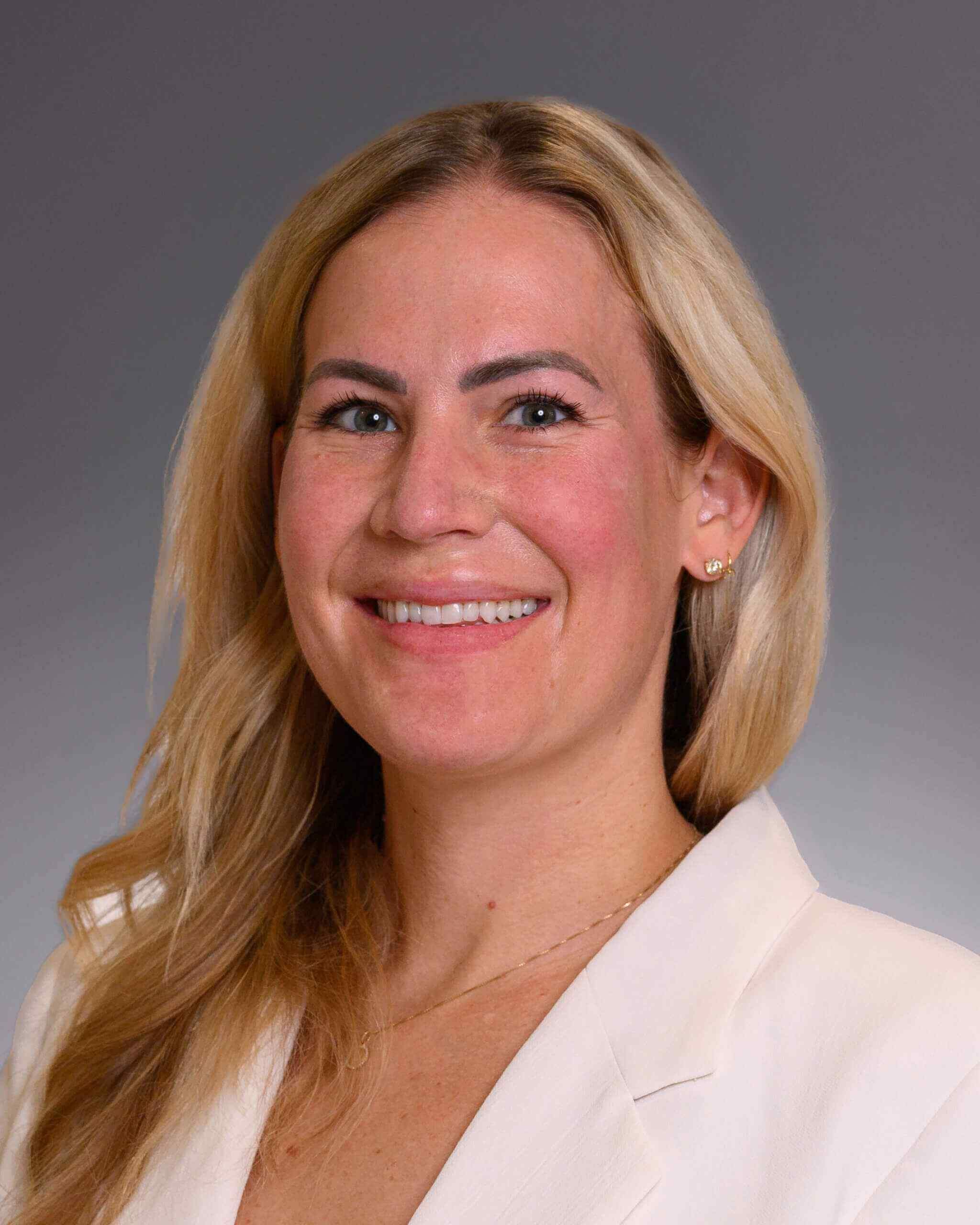 Woman in a white blazer, Sydney Harman Board-Certified in Anesthesiology at Forte Sports Medicine