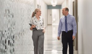 Two people walk through a hallway at Forte Sports Medicine, a physician-owned practice