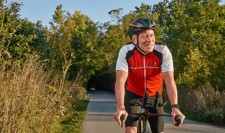 Cyclist on paved road promoting hip pain orthopedic care at Forte Sports Medicine