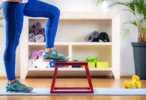 woman doing step up exercises at home
